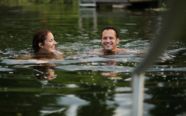 couple swimming in the natural swimming lake